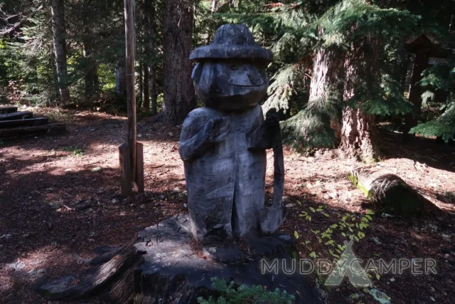 a statue of a man in a forest